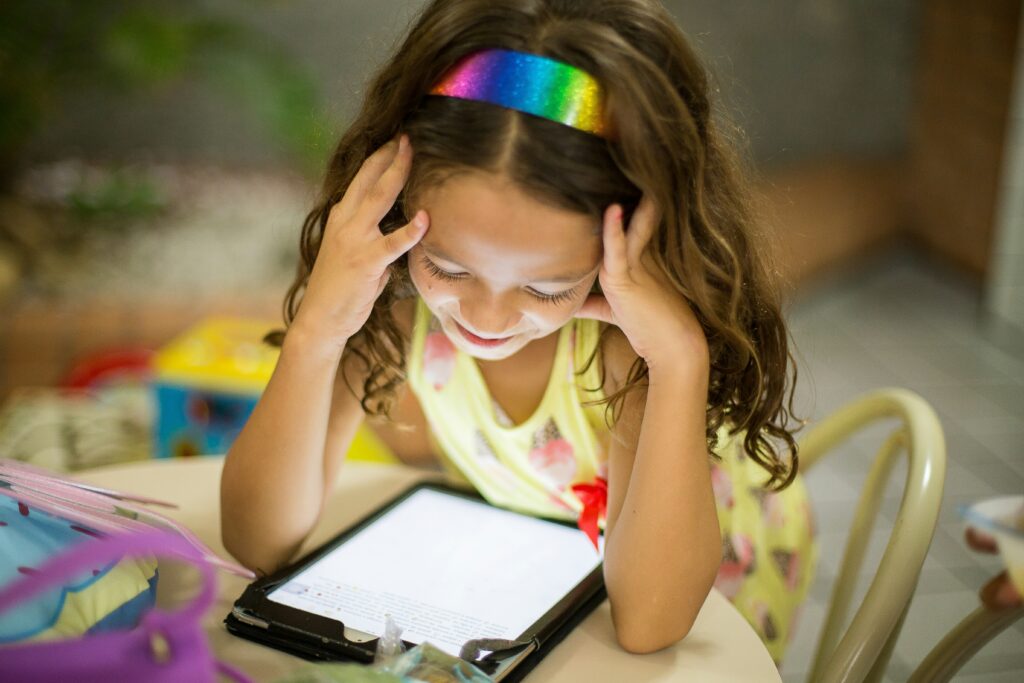 must-have classroom websites. A child on iPad looking at essential websites and online programs for classroom use